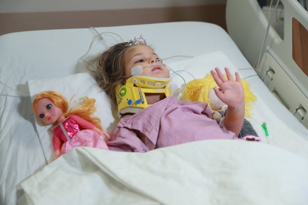 Quake survivor Ayda Gezgin lies on a stretcher in hospital with a doll after being pulled from the debris...