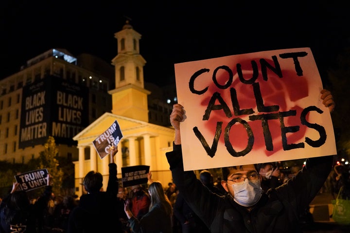 A demonstrator holds up a sign while waiting for election results at Black Lives Matter Plaza, on Nov. 3, 2020, in Washington