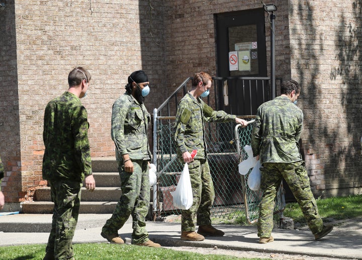 Military personnel are seen changing shifts behind the Eatonville Care Centre in Toronto, Ont. on May 26, 2020.