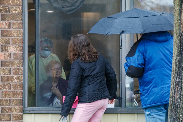 A family has a window visit with their mother at Orchard Villa in Pickering, Ont. on Mother's Day, May 10, 2020 