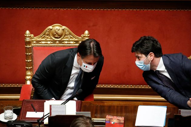 The Italian Prime Minister, Giuseppe Conte, and the Italian Health Minister, Roberto Speranza, both wearing masks ...