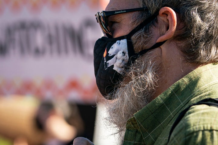 An activist wears a face covering with a polar bear holding a molotov cocktail during a protest in Washington, D.C., on Wedne
