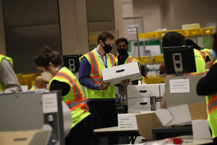 Election workers count ballots on Wednesday in Philadelphia. Despite the president's unfounded claims, voting appeared to go fairly smoothly in Pennsylvania. 