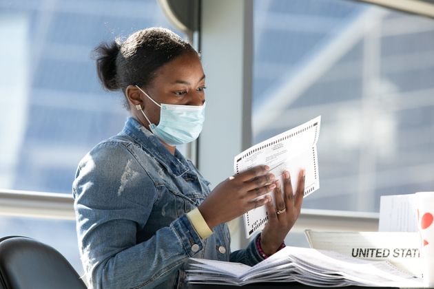 An employee is working on a vote-by-mail ballot count.  Atlanta Georgia.  2020