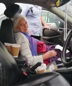 Woman being taken out of care home 