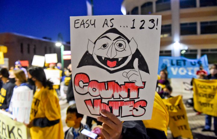 A rally participant holds a sign with a drawing of The Count in Reading, Pennsylvania, on Wednesday.