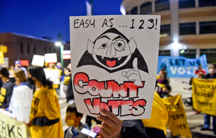 A rally participant holds a sign with a drawing of The Count in Reading, Pennsylvania, on Wednesday.