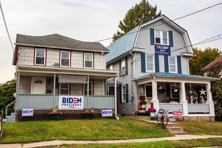 Neighboring houses in Northumberland, Pennsylvania, display signs for opposing presidential candidates. Friendships across party lines are becoming uncommon -- and even family members are at odds.