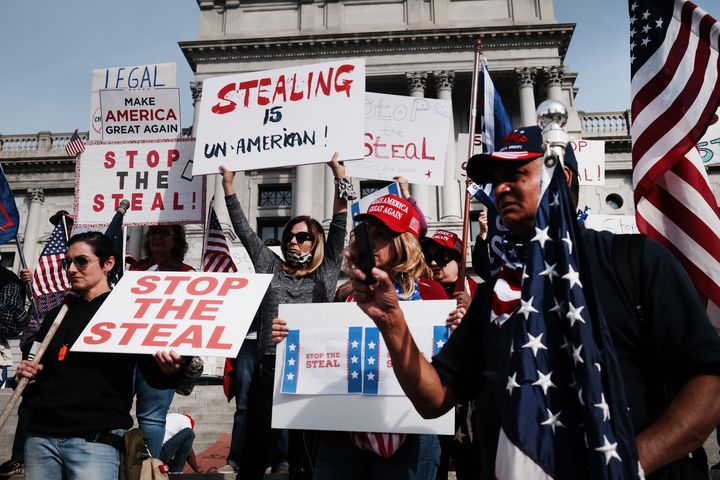 Dozens of people calling for stopping the vote count in Pennsylvania due to alleged fraud against President Donald Trump gather Thursday on the steps of the state Capitol in Harrisburg.