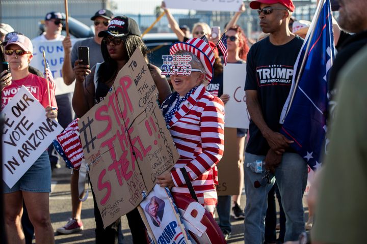 Trump supporters gather Thursday in the parking lot at the Maricopa County Tabulation and Election Center in Phoenix.