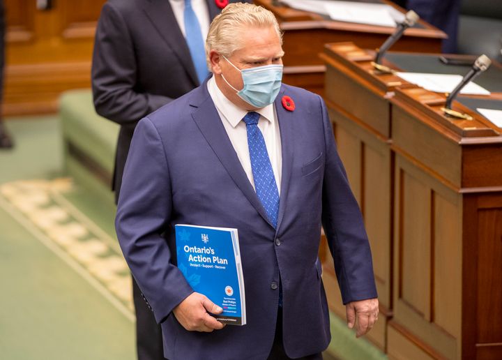 Ontario Premier Doug Ford carries the Ontario 2020 Budget as he arrives in the legislature in Toronto on Nov. 5, 2020. 