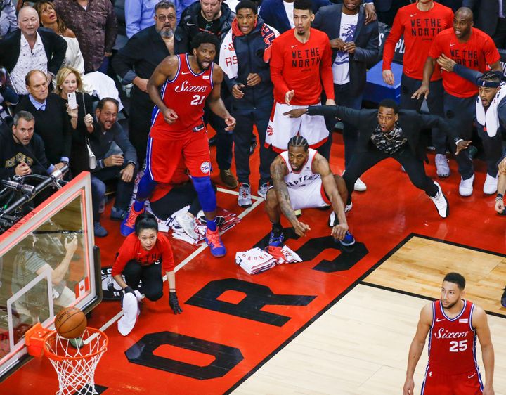 Philadelphia 76ers center Joel Embiid (21) and Toronto Raptors forward Kawhi Leonard (2) watch as the ball bounces around the rim in the final seconds of Game 7 of NBA playoff play at Scotiabank Arena in Toronto.