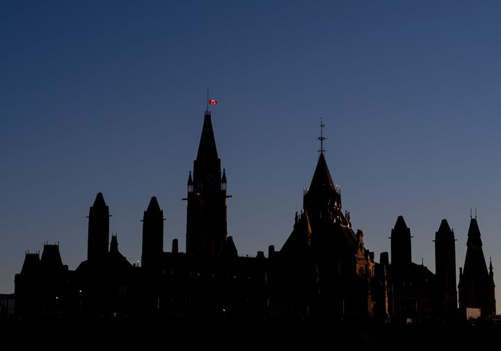 The Canada flag flies at half mast on the Peace Tower on Parliament Hill in Ottawa on Nov. 4, 2020. in honour of Samuel Paty who was murdered in France last week. 