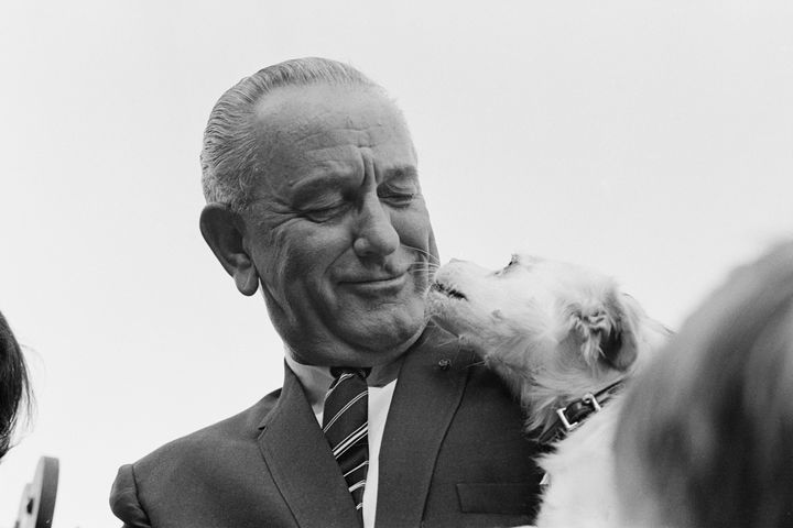 President Lyndon B. Johnson introduces his pet dog Yuki on the South Lawn of the White House in September 1967.
