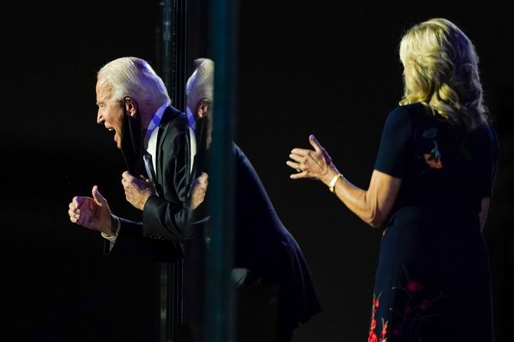 President-elect Joe Biden reacts on stage with Jill Biden after speaking, Saturday, Nov. 7, 2020, in Wilmington, Del. (AP Photo/Carolyn Kaster)