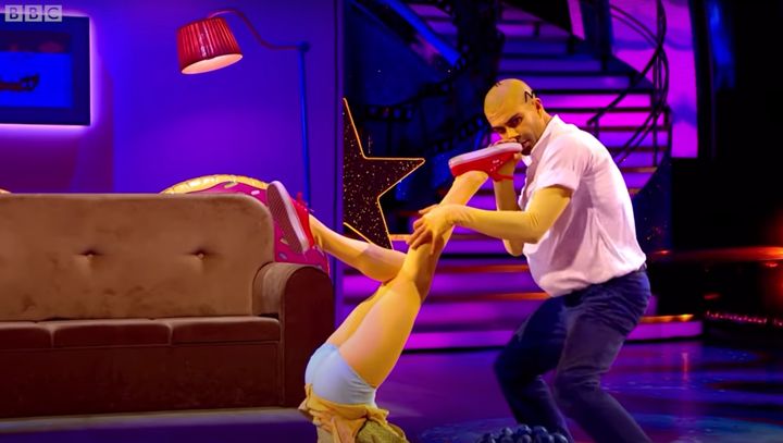 Max George playing Dianne Buswell's leg like a saxophone during their Simpsons performance
