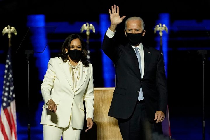 President-elect Joe Biden, right, on stage with Vice President-elect Kamala Harris, left, Saturday, Nov. 7, 2020, in Wilmington, Del. (AP Photo/Andrew Harnik, Pool)