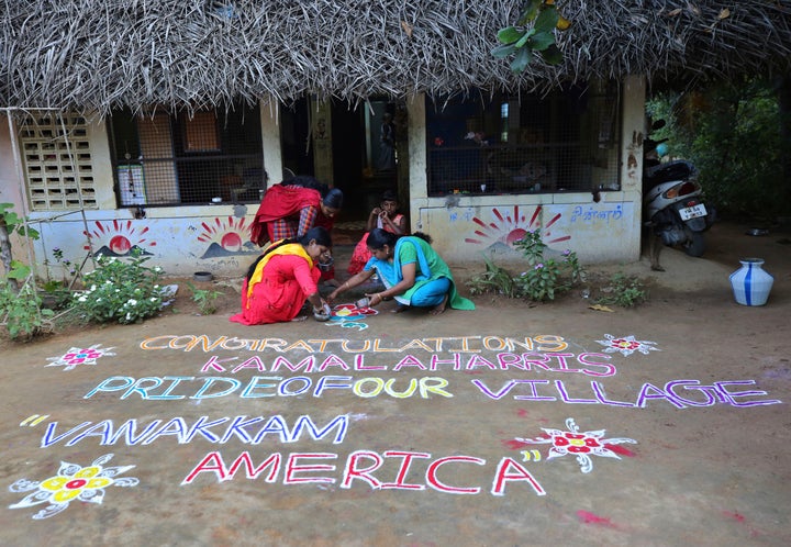 Indian women prepare a Kolam, a traditional art work using colored powder, congratulating Harris in the hometown of Harris' m