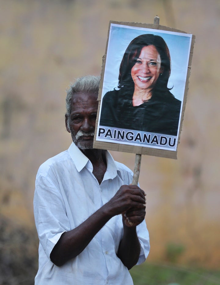 An elderly villager holds a placard of the U.S. vice president-elect during celebrations for her victory in Painganadu, a nei