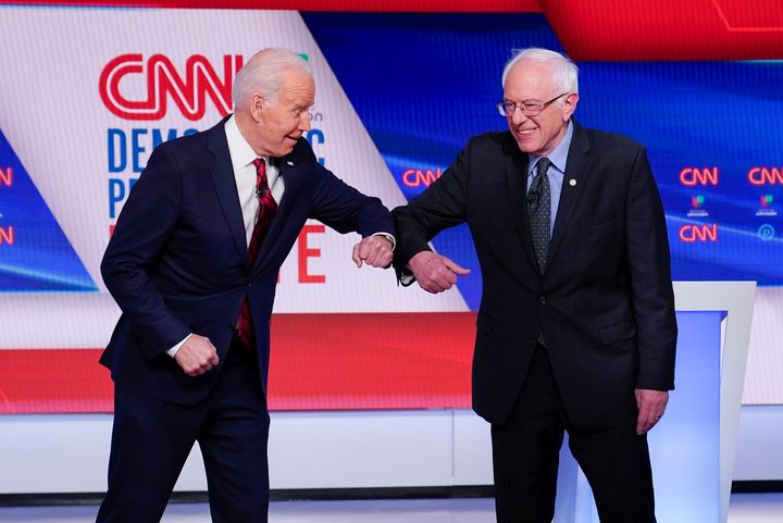 In this March 15, 2020, file photo, former Vice President Joe Biden, left, and Sen. Bernie Sanders, I-Vt., right, greet one another before they participate in a Democratic presidential primary debate at CNN Studios in Washington. (AP Photo/Evan Vucci, File)