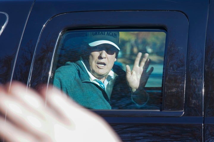 President Donald Trump waves to supporters as he departs after playing golf at the Trump National Golf Club in Sterling Va., on Nov. 8, 2020.