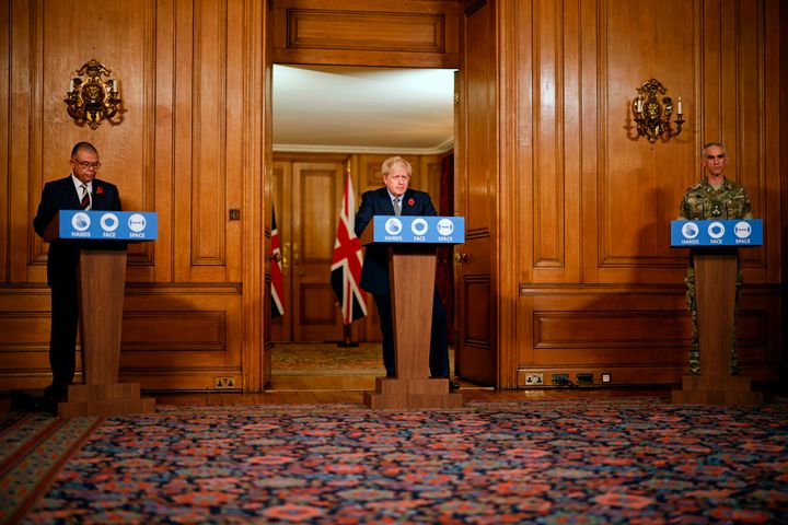 Britain's Prime Minister Boris Johnson (C) speaks flanked by British Army Brigadier Joe Fossey (R) and Britain's Deputy Chief Medical Officer for England Jonathan Van-Tam (L) during a virtual press conference on the coronavirus pandemic in the UK inside 10 Downing Street in central London on November 9, 2020. (Photo by Tolga Akmen / POOL / AFP) (Photo by TOLGA AKMEN/POOL/AFP via Getty Images)