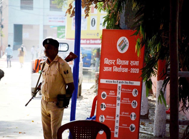 A security personnel stands guard outside the strong room at AN College on the eve of assembly election...