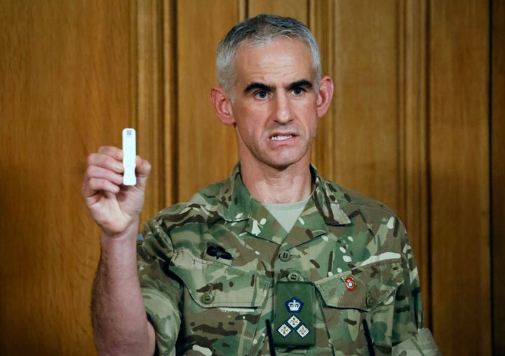 British Army Brigadier Joe Fossey, who is coordinating the mass coronavirus testing pilot in Liverpool, holds up the components of a lateral flow Covid-19 test as he speaks during a virtual press conference on November 9