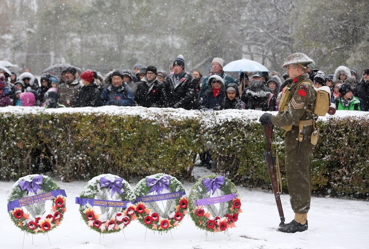 Part of the honour guard, Colin Pinn wears the World War 2 uniform of the 48th Highlanders in the snow as Fort York National Historic site hosts Remembrance Day in the Strachan Avenue Military Cemetery in Toronto, Ont. on Nov. 11, 2019. 