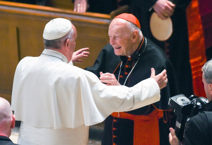 In this Sept. 23, 2015 file photo, Pope Francis reaches out to hug Cardinal Archbishop emeritus Theodore McCarrick after the