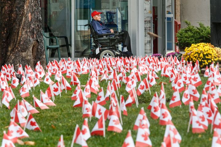 Richard Johnstone, 92, is framed by some of the 30,000 Canadian flags that were place around the Sunnybrook Veterans Centre on Remembrance Day in 2015. Johnstone served in the Canadian Navy in the Far East, Middle East and North Atlantic and survived 11 days in a life raft. 