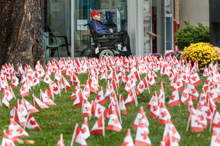 Richard Johnstone, 92, is framed by some of the 30,000 Canadian flags that were place around the Sunnybrook Veterans Centre on Remembrance Day in 2015. Johnstone served in the Canadian Navy in the Far East, Middle East and North Atlantic and survived 11 days in a life raft.