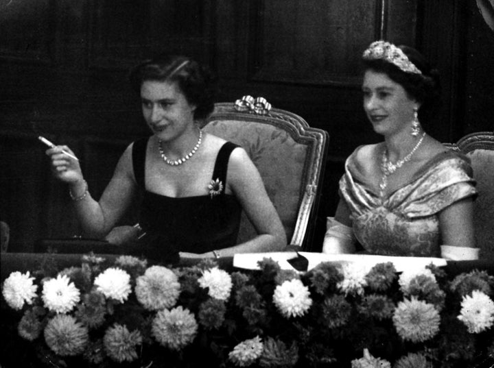 A young Princess Margaret smoking while watching the Royal Variety Performance with her sister, Queen Elizabeth.