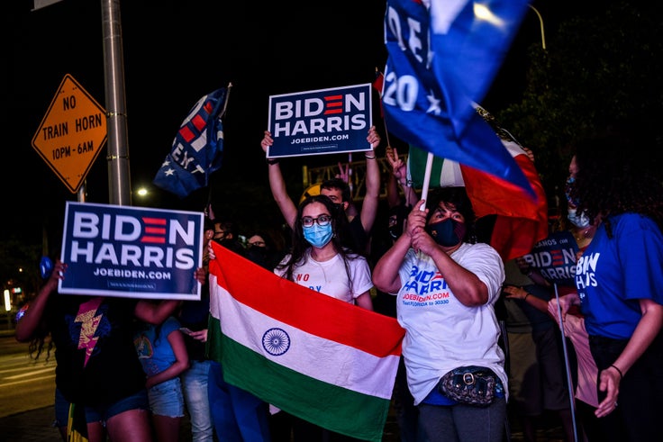 A supporter holds a national flag of India at a watch party in Miami as President-elect Joe Biden and Vice President-elect Kamala Harris deliver victory remarks on Nov. 7, 2020.