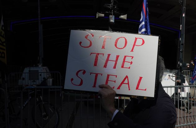 A Trump supporter holds a sign outside the Pennsylvania Convention Center in Philadelphia after Joe Biden was projected the winner of the 2020 presidential election on Nov. 7.