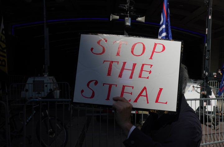 A Trump supporter holds a sign outside the Pennsylvania Convention Center in Philadelphia after Joe Biden was projected the winner of the 2020 presidential election on Nov. 7.