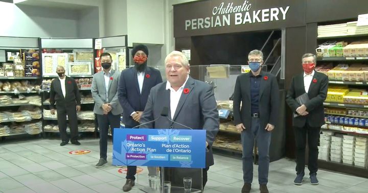 Ontario Premier Doug Ford takes questions from reporters at a North York, Ont. bakery Tuesday.