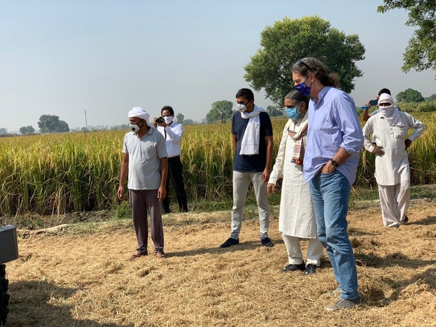 Lindner, along with farmers, checks stubble management machines at a village on the Punjab and Haryana
