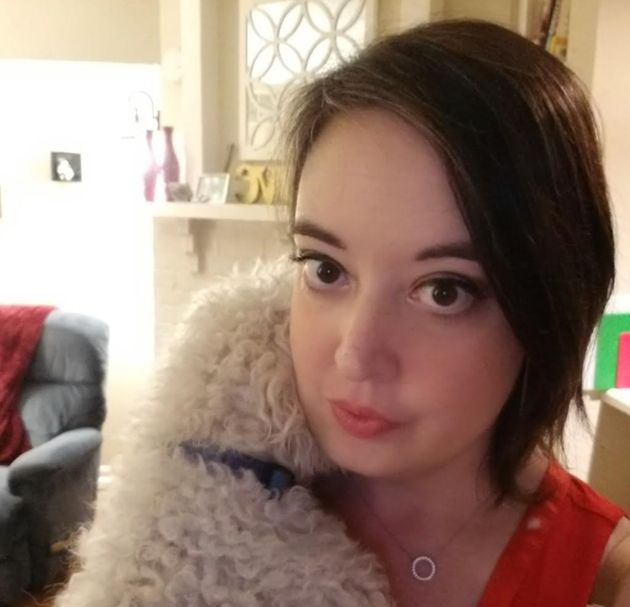 The author hugs one of her dogs in her apartment.