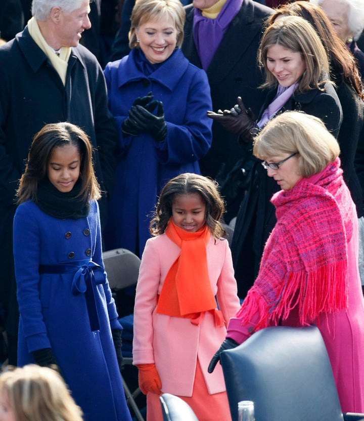 Malia and Sasha Obama pass former President Bill Clinton, then-Sen. Hillary Clinton, and Jenna Bush as they are shown to thei