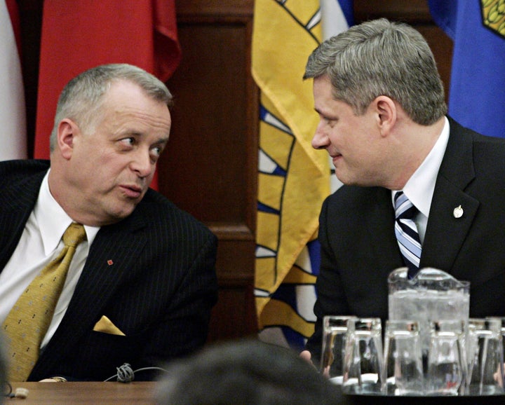 Jay Hill chats with Prime Minister Stephen Harper at a Conservative caucus meeting in Ottawa on Feb. 7, 2006.