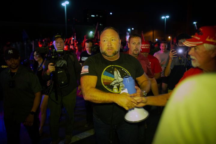 After making a violent speech outside the elections center on Thursday night, far-right radio host Alex Jones returned the next night, Nov. 6, 2020, to rile up the crowd again.