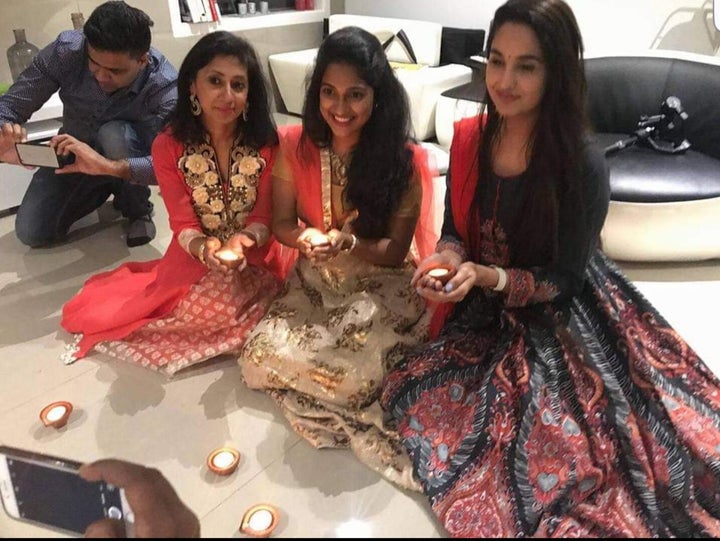 Molina Asthana and Indian playback singer Satya Yamini hold diya lamps during a previous Diwali celebration.