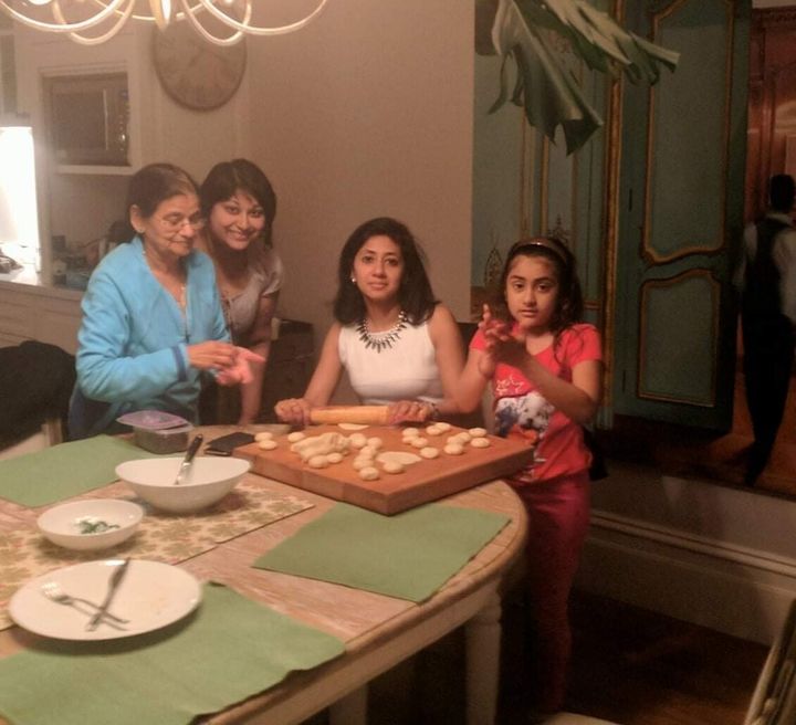 Molina Asthana preparing food with her family. She says that Diwali is usually "a time for sharing, for joy and positivity."