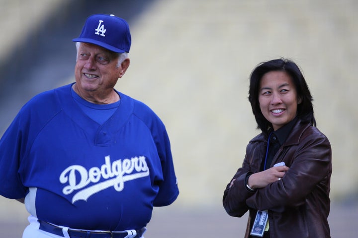 Kim Ng, then the assistant general manager of the Los Angeles Dodgers, talks with former Dodgers manager Tommy Lasorda.