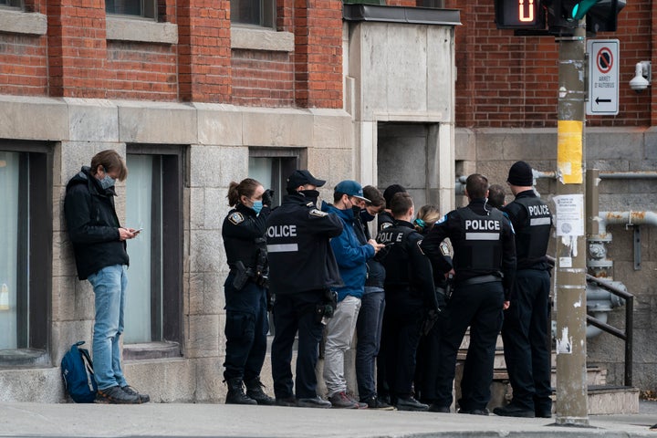 Police assemble outside the entrance to the Ubisoft building in Montreal's Mile End neighbourhood, Nov. 13, 2020.