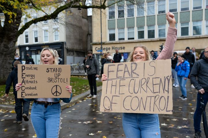 Protesters hold placards on College Green during the protest. 