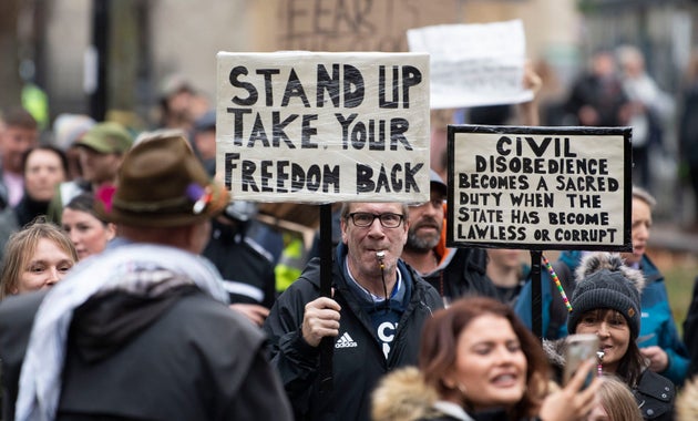 Protestors hold signs as they march through the city.