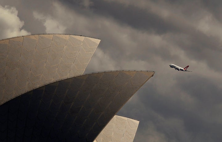 A Qantas A-380 plane flies past the Sydney Opera house in central Sydney, Australia March 11, 2013. 