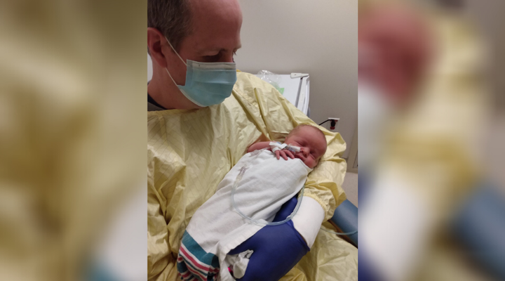 Dave McIntosh holds his newborn son in the Abbotsford Regional Hospital in Abbotsford, B.C., in this undated photo. The father of two says his wife is in stable condition in an induced coma and on a ventilator. 